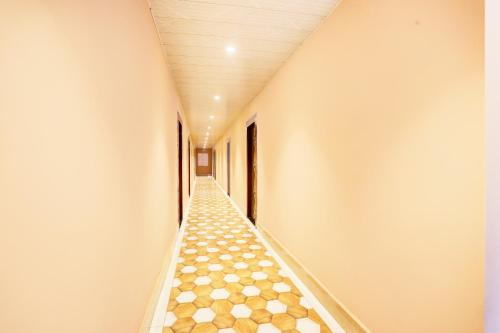 an empty corridor with a tiled floor in a building at Hotel O Stay Inn in Patna