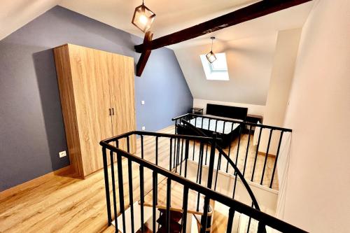 a room with a staircase leading to a living room at Luxury Duplex Auxonne Center in Auxonne