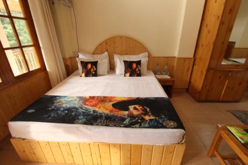 a bedroom with a large bed in a room at Hotel Purnima Kasol in Kasol
