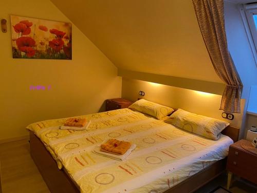 a bedroom with a bed with two plates on it at Birkenstübchen in Lautenthal