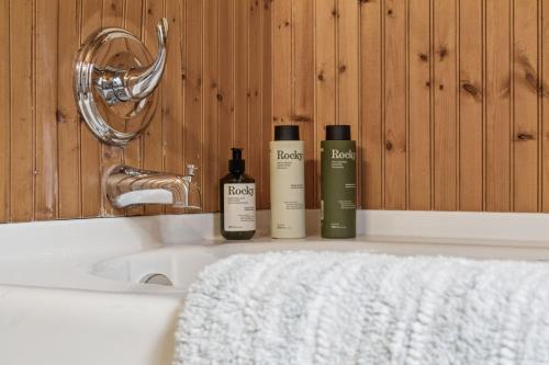 a bathroom with two bottles of soap and a sink at Nordegg Timber Estate in Nordegg