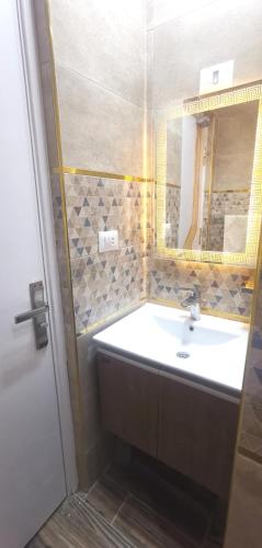 a bathroom with a sink and a mirror at Aladdin hotel Egypt badr in Badr