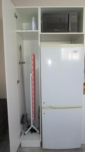 a kitchen with a refrigerator and a microwave at The Falcon in Windhoek