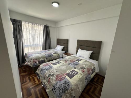 Ένα ή περισσότερα κρεβάτια σε δωμάτιο στο VIVE Apartments Cusco