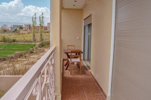a balcony with a table and chairs and a view at Perfect Stop in Midelt in Midelt