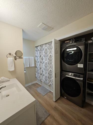 a small kitchen with a sink and a microwave at Hillside Retreat in Knoxville