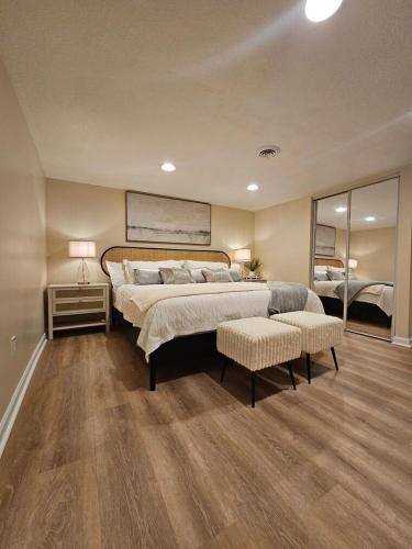 a large bedroom with a large bed and a mirror at Hillside Retreat in Knoxville