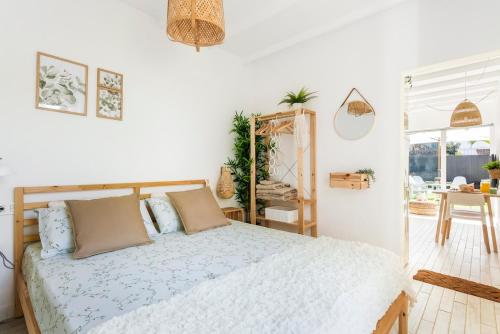 ein weißes Schlafzimmer mit einem Bett und einem Tisch in der Unterkunft Little LuxuryHouse Puerto de la Cruz in Puerto de la Cruz