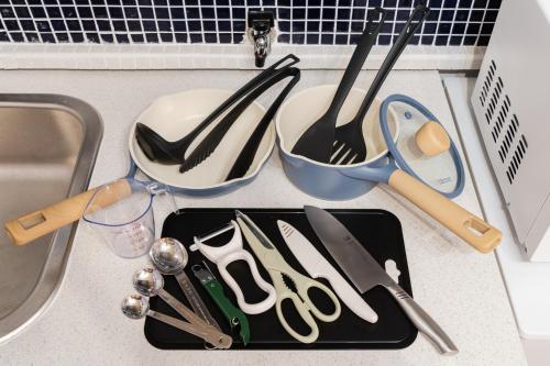 a tray of utensils on a counter next to a sink at EDO GATEI Sakura Biyori Stay in Tokyo