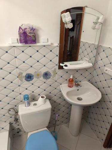 a white bathroom with a toilet and a sink at Apartment in Villa - Tangier in Tangier