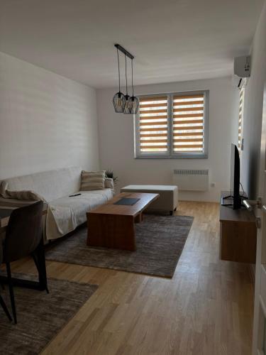 a living room with a couch and a coffee table at MH apartment in Vranješ
