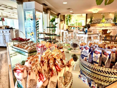 a display case in a store filled with food at Hotel Aquila D'Oro Desenzano in Desenzano del Garda