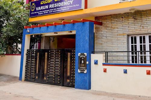 an entrance to a restaurant with a blue door at Hotel O Varun Residency in Bengaluru