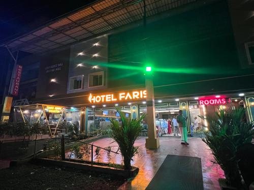 a green traffic light in front of a hotel at night at FARIS ROOMs in Malappuram