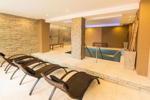 a lobby with chairs and a swimming pool at Hotel Paucam in Santa Teresita