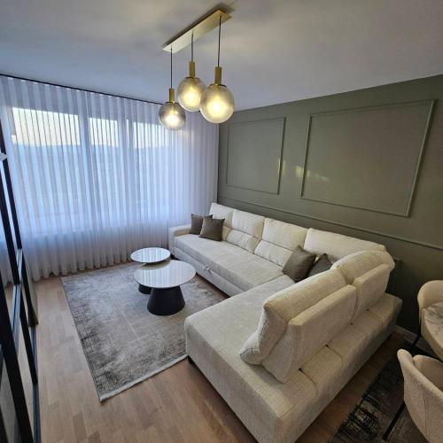 a living room with a couch and a table at Apartment Sarajevo Airport1 in Sarajevo