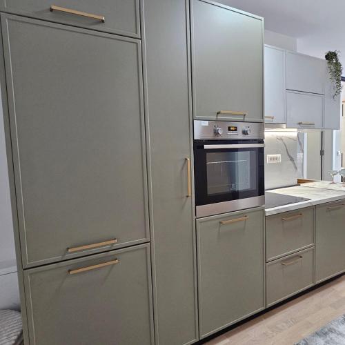a kitchen with a stainless steel refrigerator and an oven at Apartment Sarajevo Airport1 in Sarajevo
