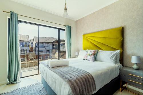 a bedroom with a bed and a large window at Nom’s Amsterdam in Northriding