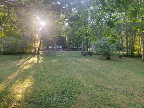 a park with two picnic tables in the grass at Eedu suvila in Saaremaa