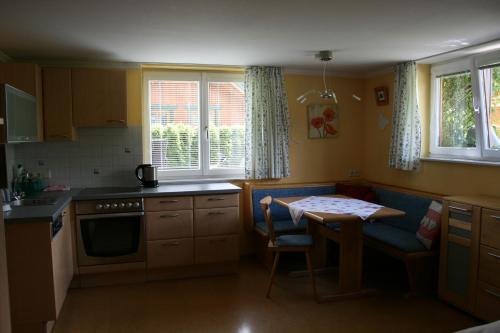 a kitchen with a table and a small kitchen with a table at Haus Bergliebe in Schladming