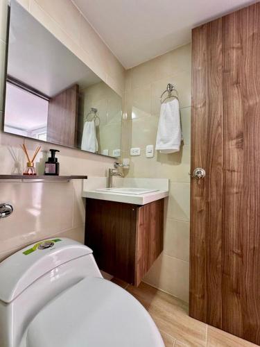 a bathroom with a white toilet and a sink at Villas del mar in Cartagena de Indias