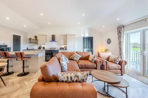 a living room with a couch and a table at Moorview Lodge in Sparkwell