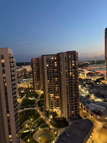 a view of a city at night with tall buildings at Belgrade Waterfront apartments in Belgrade