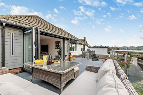 a patio with a couch and a table at Greenacres in Chittlehampton