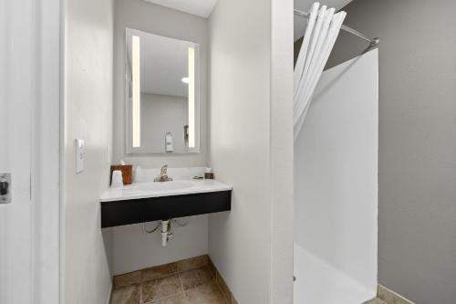 a bathroom with a sink and a mirror at GrandStay Residential Suites Rapid City in Rapid City