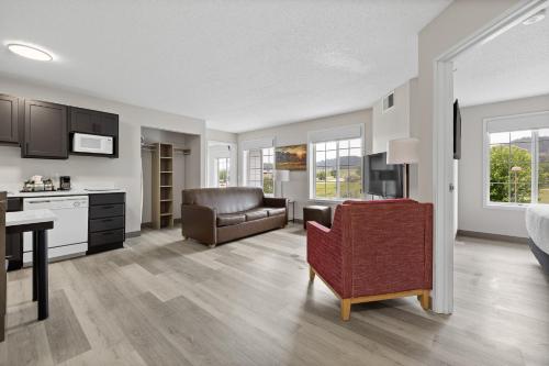 a living room with a couch and a chair in a room at GrandStay Residential Suites Rapid City in Rapid City