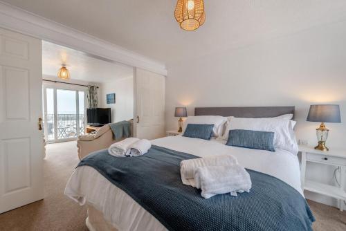 a bedroom with a large bed with towels on it at Landfall in Saundersfoot