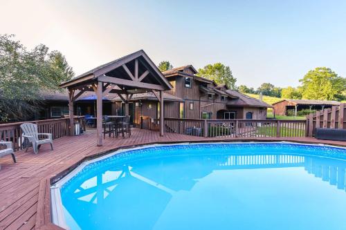 a pool on a deck with a house at Liberty Lodge Pool & Hot Tub Game Room BBQ in McArthur