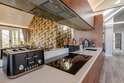 a kitchen with a black and white stove top oven at The Cowshed - Haceby in Haceby