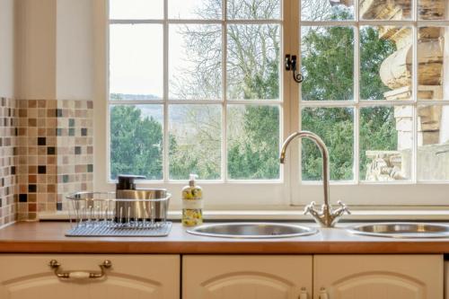 a kitchen with a sink and a window at North Wing Top Apartment in Bunny