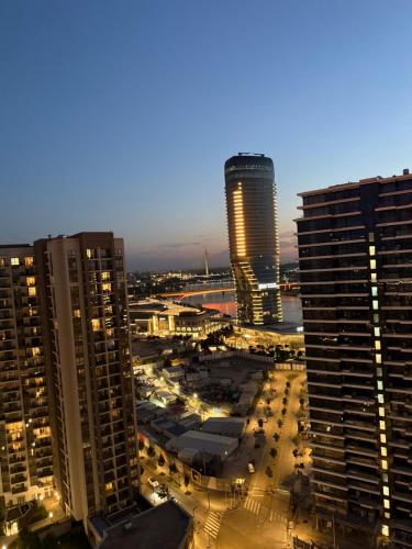a view of a city at night with tall buildings at Belgrade Waterfront apartments in Belgrade