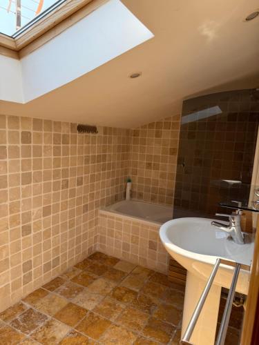 a bathroom with a sink and a bath tub at Duplex with spacious terraces and stunning sea views, right next to the beach in Jávea