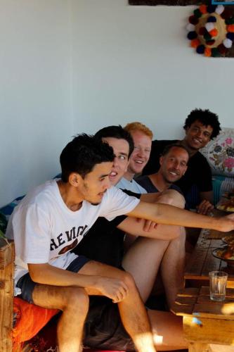 a group of men are posing for a picture at hostel SmiGle in Tamraght Oufella