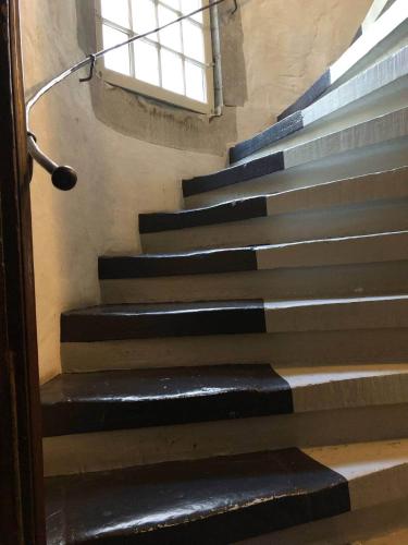 a set of stairs in a building with a window at Steps To Bern's Best Historic Sites! in Bern