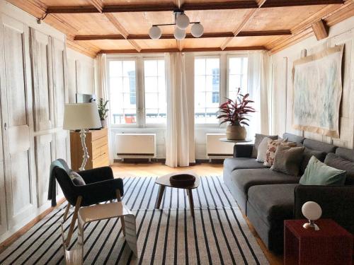 a living room with a couch and a table at Steps To Bern's Best Historic Sites! in Bern