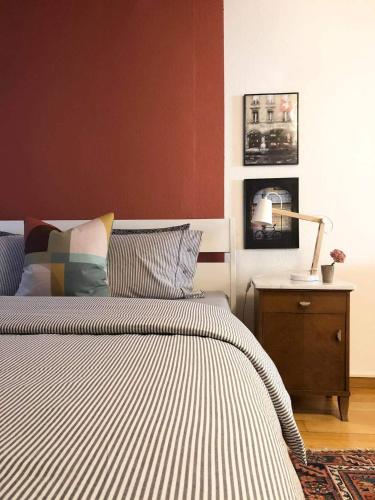 a bedroom with a bed and a table with a lamp at Steps To Bern's Best Historic Sites! in Bern