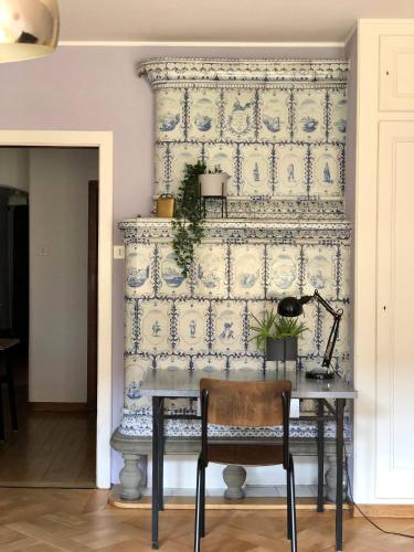 a dining room table with a blue and white wall at Unesco Heritage & Steps To Bern's Sites! in Bern