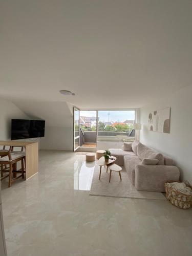 a living room with a couch and a table at Dom View Luxury Apartment in Cologne