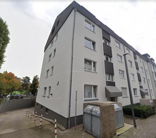 a white building with a black roof at Dom View Luxury Apartment in Cologne
