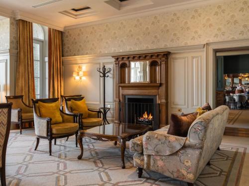a living room filled with furniture and a fireplace at Lough Erne Resort in Enniskillen