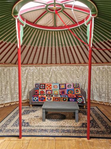 a living room with a couch in a yurt at Nomad's Cottage and Yurt 