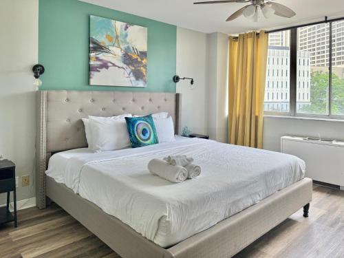 a bedroom with a bed with a teddy bear on it at Atlanta Downtown! High Rise! Onsite Parking Multi Unit in Atlanta