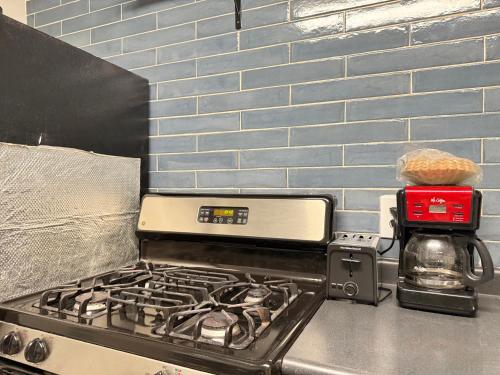 a stove top oven sitting on top of a kitchen counter at Atlanta Downtown! High Rise! Onsite Parking Multi Unit in Atlanta