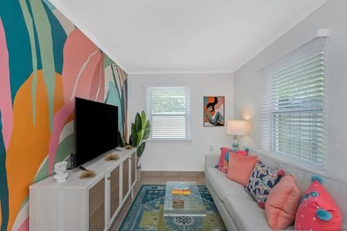 a living room with a couch and a flat screen tv at Mermaid Tropical Villa in Largo