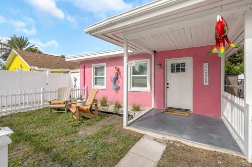 a pink house with a white fence at Mermaid Tropical Villa in Largo