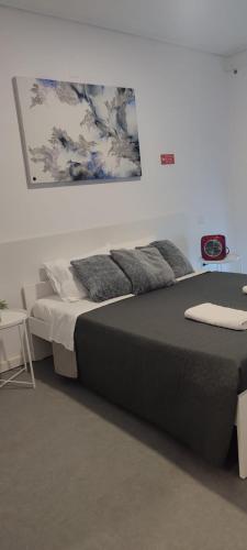a bedroom with a large bed with pillows on it at Porta 80 House in Braga